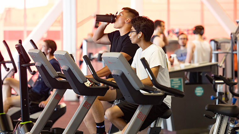 Two students use ellipticals in Foster Recreation Center.