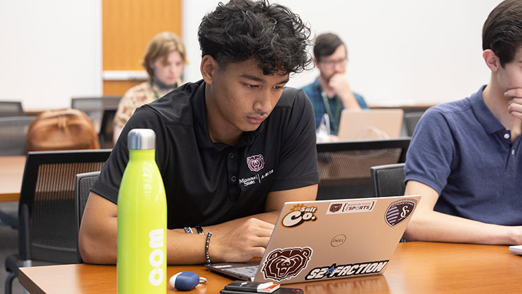 A student uses a laptop in his class.