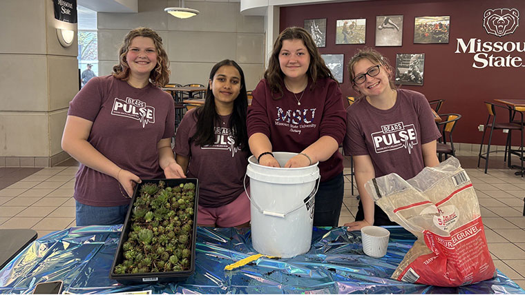 Four BearsPulse students prepare an activity for students involving planting succulents.